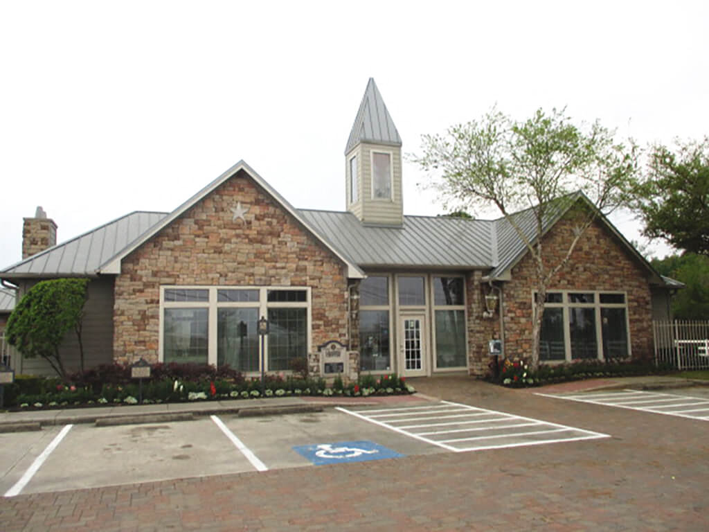 The building exterior of the leasing center at the Fallbrook Ranch Apartments in Houston, Texas.